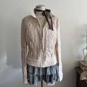Baby pink quilted leather jacket with panels and lace up detail